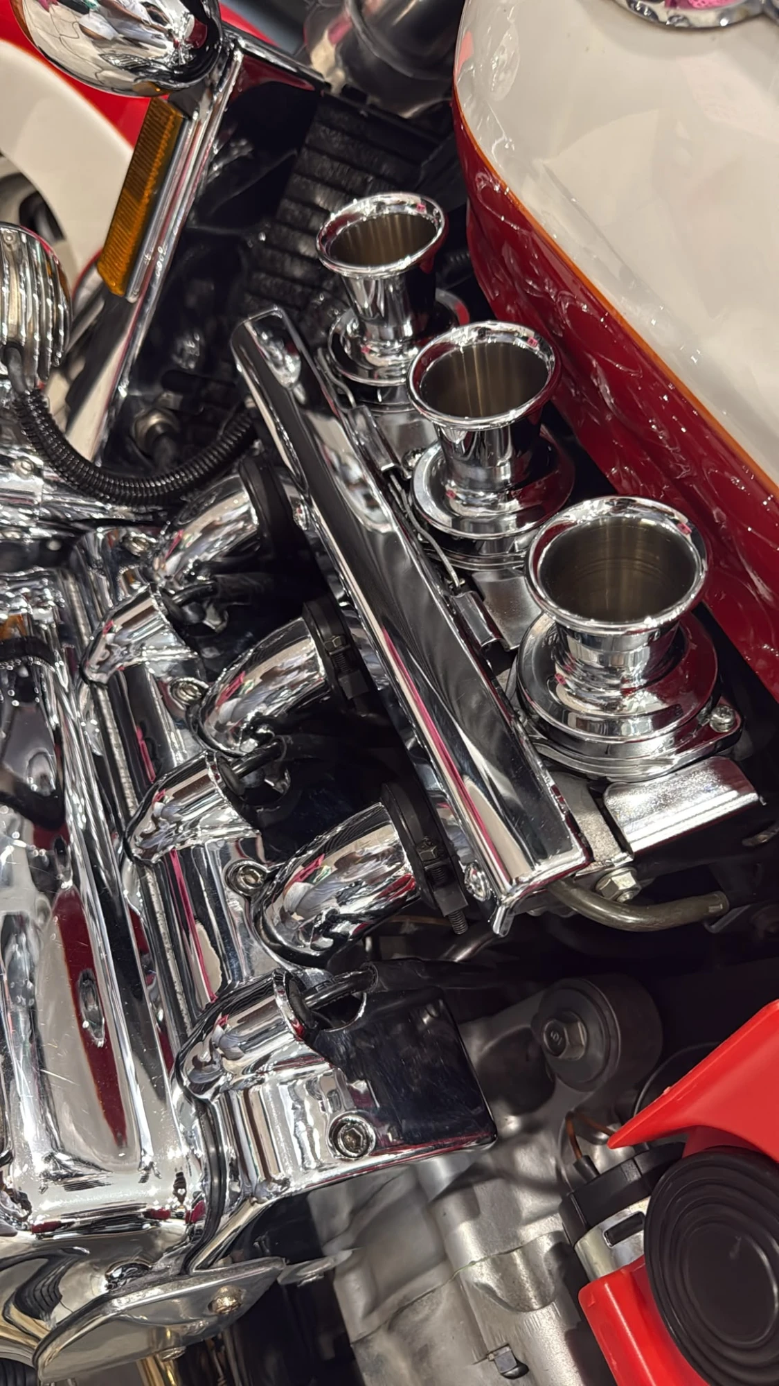 Chrome velocity stacks on a six-cylinder engine
